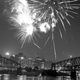 Fireworks explode over the Point, the Manchester (North Side Point) Bridge, and the Point Bridge.