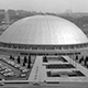 View of the completed Civic Arena showing the landscaping and layout of the area. The Civic Arena was the only stadium of its kind with a retractable dome constructed using eight stainless steel panels, six of which moved under the two stationary panels. Originally built for the Civic Light Opera, it is mostly known as the home of Pittsburgh's NHL team, the Pittsburgh Penguins.
